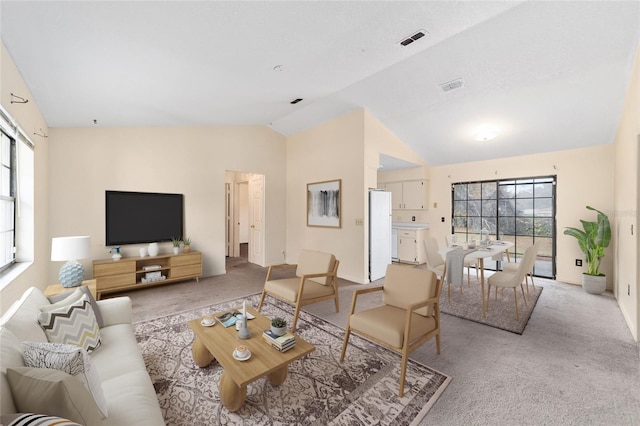 carpeted living room featuring lofted ceiling and a wealth of natural light