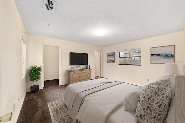 carpeted bedroom with a textured ceiling