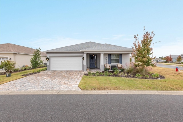 view of front of home with a garage and a front lawn