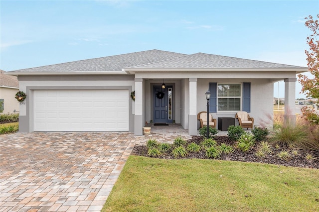 view of front of house featuring a garage and a front lawn