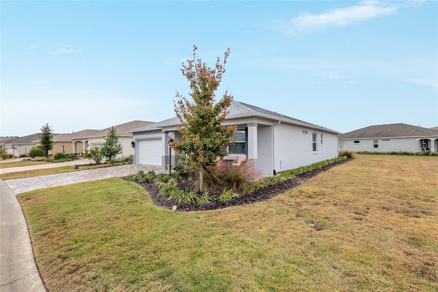 view of front of house with a front lawn and a garage