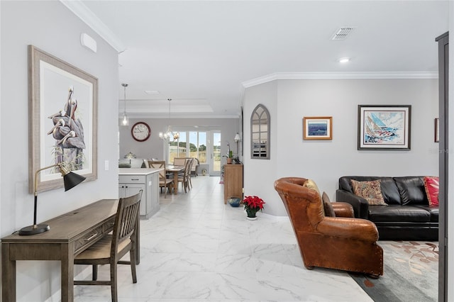 living room featuring crown molding and a chandelier