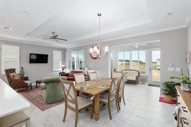 dining room featuring ceiling fan with notable chandelier, crown molding, and a tray ceiling