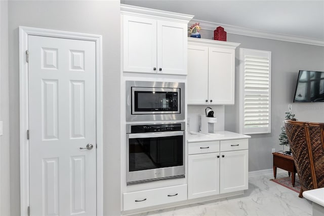 kitchen featuring white cabinetry, ornamental molding, and appliances with stainless steel finishes