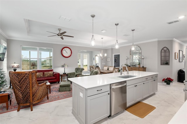 kitchen with dishwasher, a kitchen island with sink, ceiling fan with notable chandelier, crown molding, and hanging light fixtures