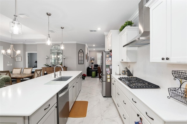 kitchen featuring a chandelier, stainless steel appliances, a kitchen island with sink, and wall chimney range hood