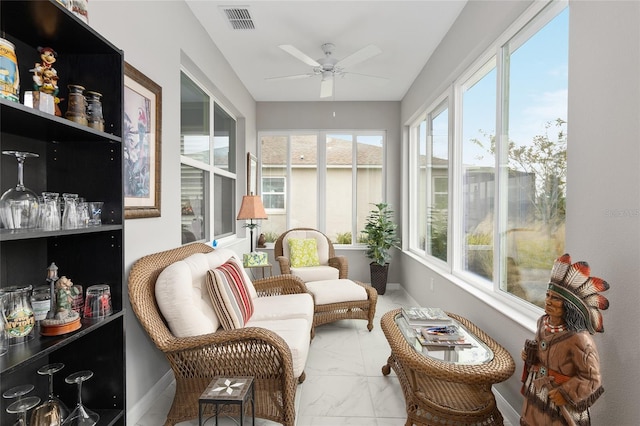 sunroom / solarium featuring ceiling fan