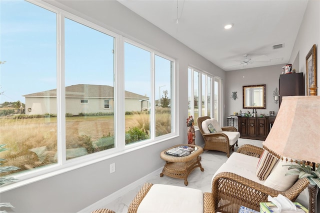 sunroom / solarium featuring ceiling fan