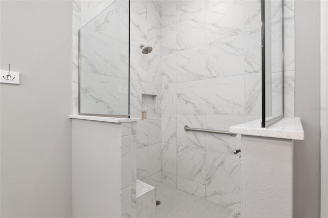 bathroom with a tile shower