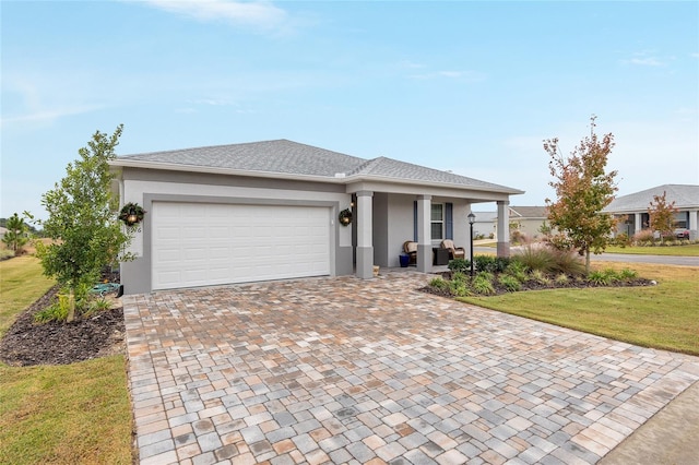 view of front facade featuring a front yard and a garage