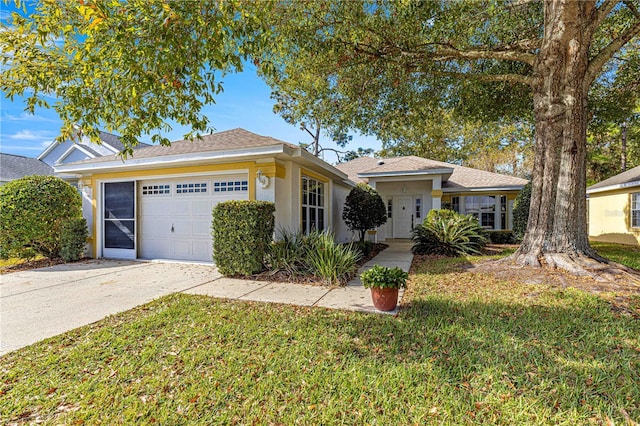 view of front facade with a garage and a front lawn