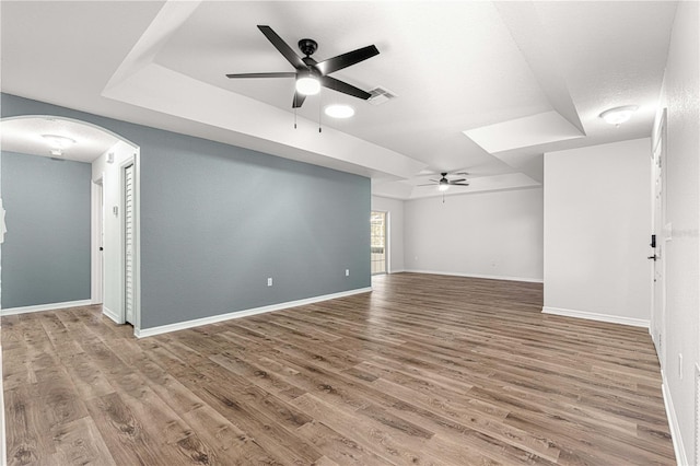 unfurnished living room with hardwood / wood-style flooring and ceiling fan