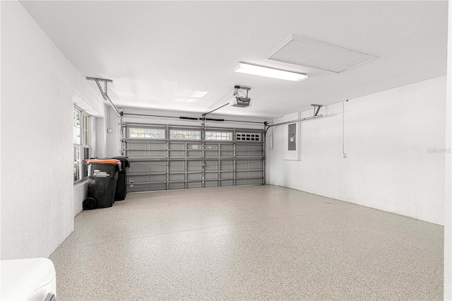 garage featuring electric panel and a garage door opener