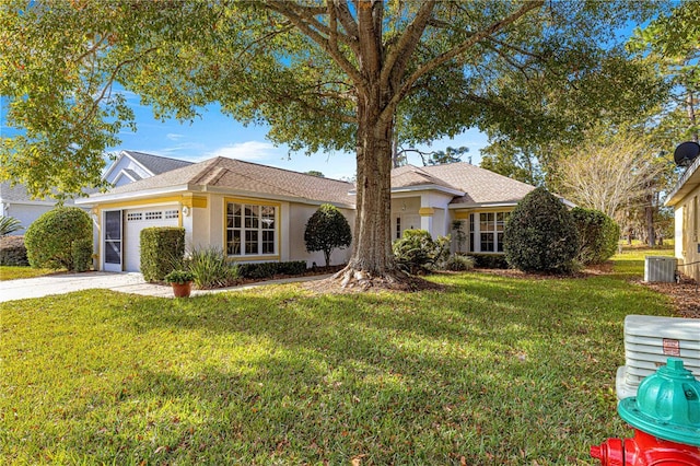 single story home featuring central AC unit, a garage, and a front yard