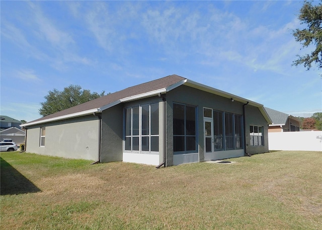 exterior space featuring a sunroom and a yard