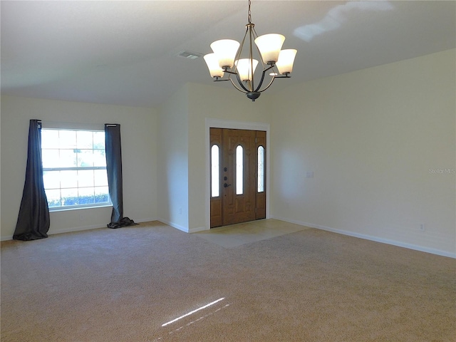 entryway with a notable chandelier and light colored carpet