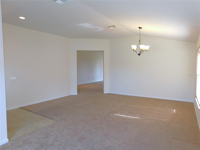 unfurnished room with carpet flooring, vaulted ceiling, and a notable chandelier