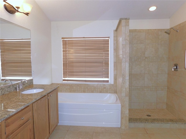 bathroom featuring tile patterned flooring, shower with separate bathtub, and vanity