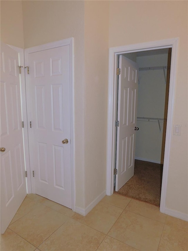 corridor with light tile patterned flooring