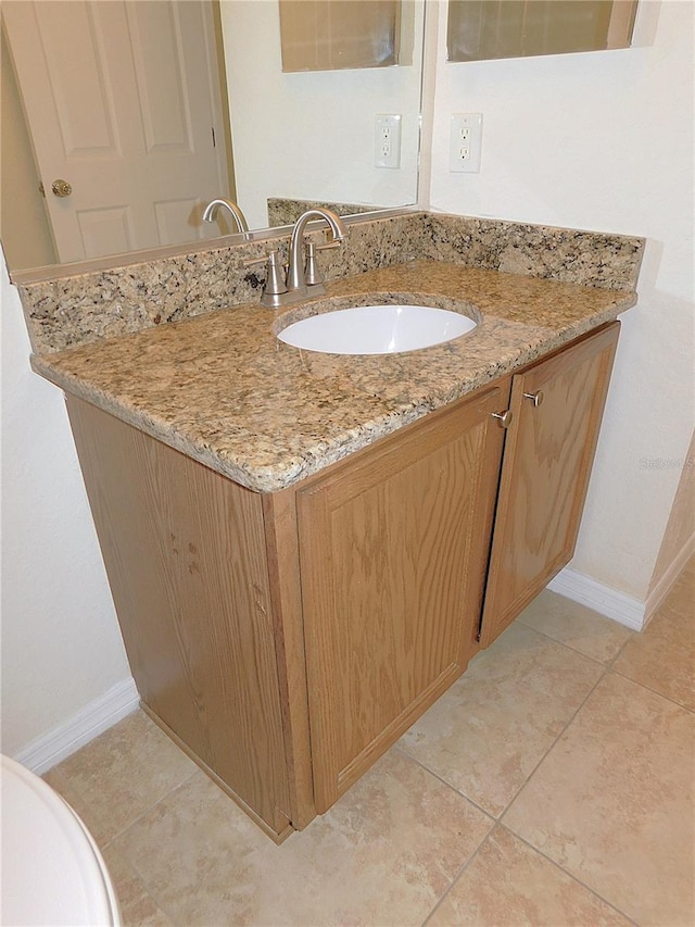 bathroom with tile patterned flooring and vanity