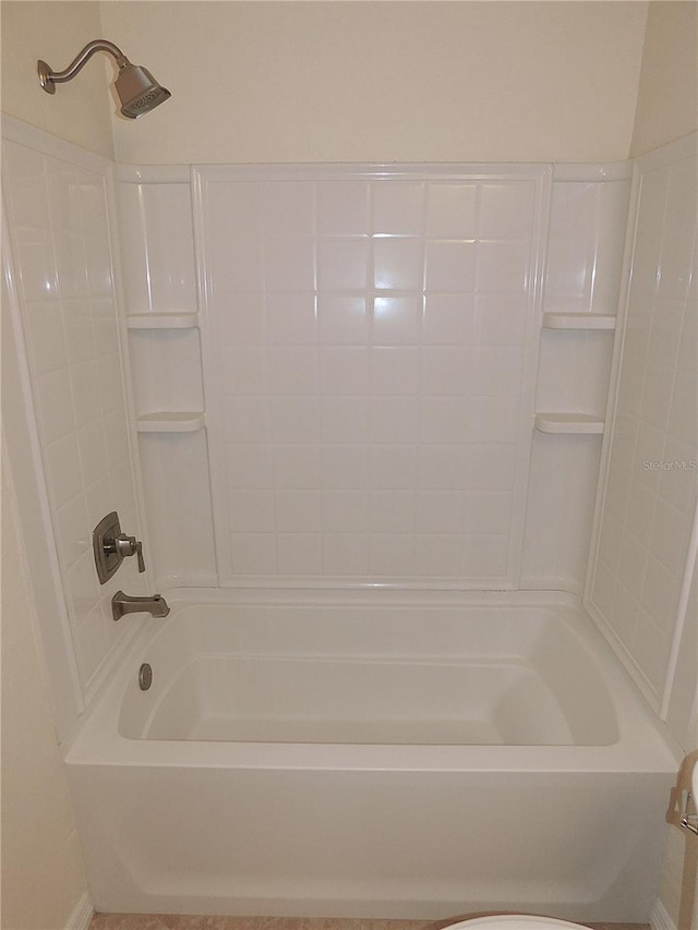 bathroom featuring toilet and tub / shower combination