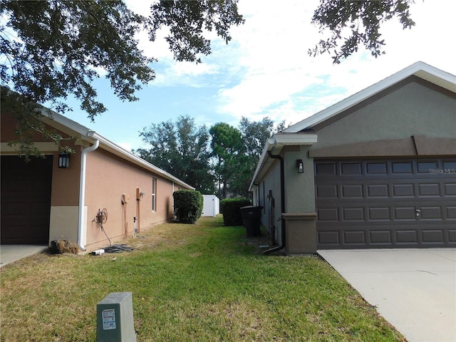 view of property exterior with a yard and a garage