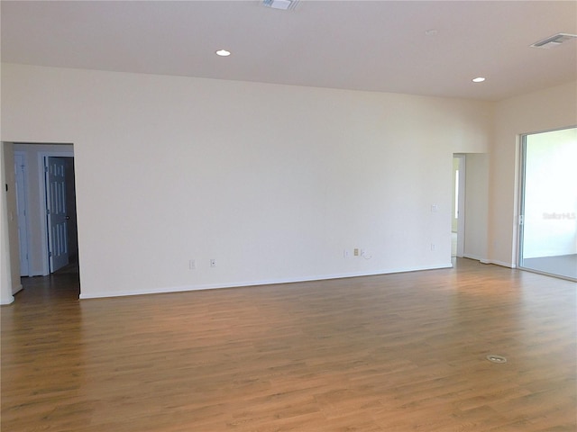 unfurnished room featuring recessed lighting, baseboards, visible vents, and wood finished floors