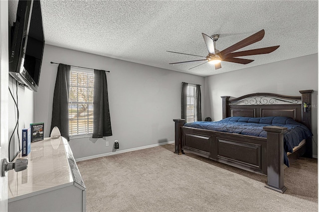 carpeted bedroom with multiple windows, ceiling fan, and a textured ceiling