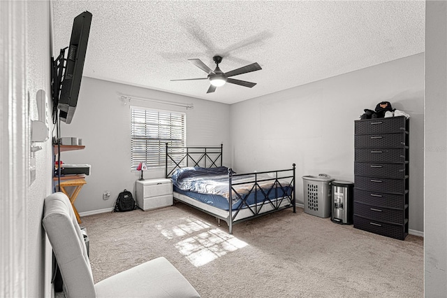 carpeted bedroom with ceiling fan and a textured ceiling