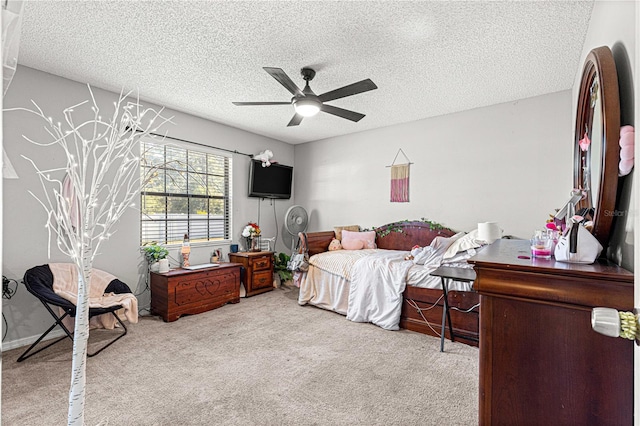 carpeted bedroom with ceiling fan and a textured ceiling