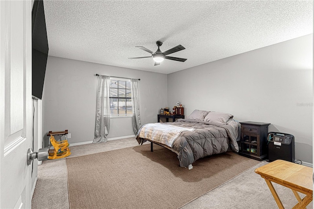 carpeted bedroom featuring a textured ceiling and ceiling fan