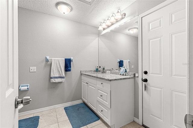 bathroom featuring tile patterned floors, vanity, and a textured ceiling