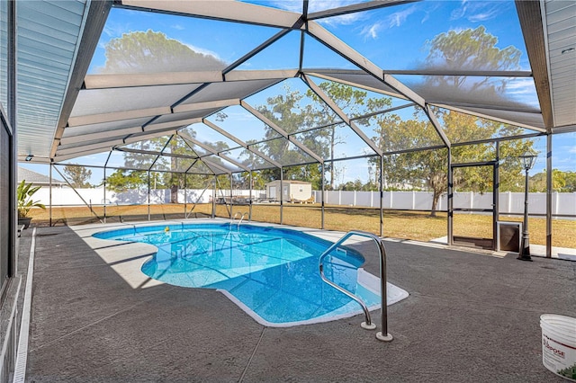 view of swimming pool featuring a patio area, a lanai, and a yard