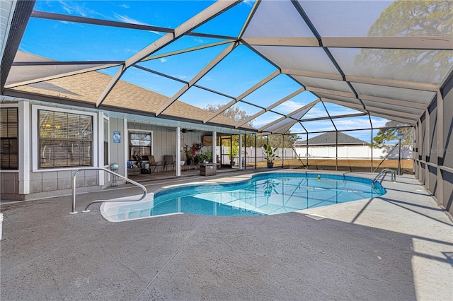 view of pool featuring glass enclosure and a patio area