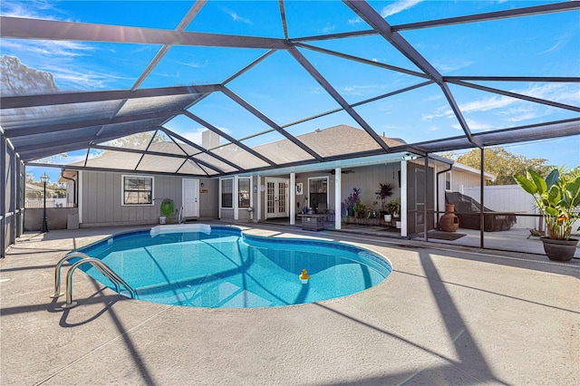 view of swimming pool with french doors, a patio, and glass enclosure