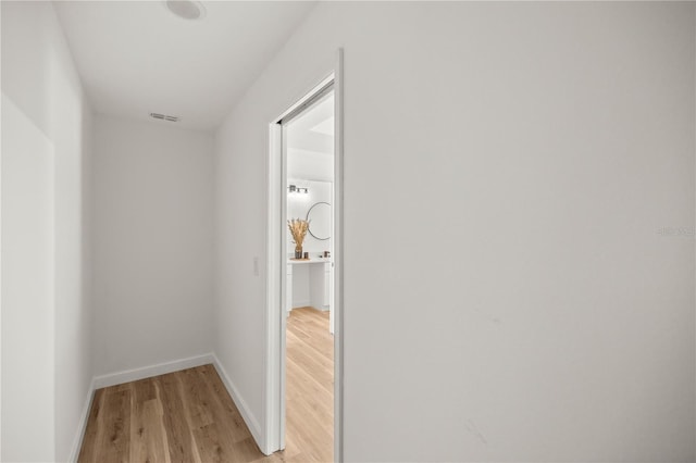 corridor with light hardwood / wood-style floors