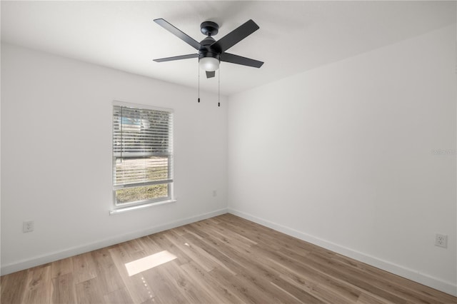 spare room featuring light wood-type flooring and ceiling fan