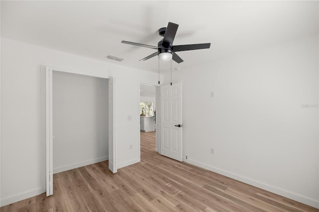 unfurnished bedroom with light hardwood / wood-style floors and ceiling fan