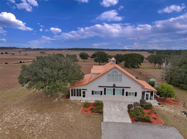 view of front of property with a rural view and a sunroom