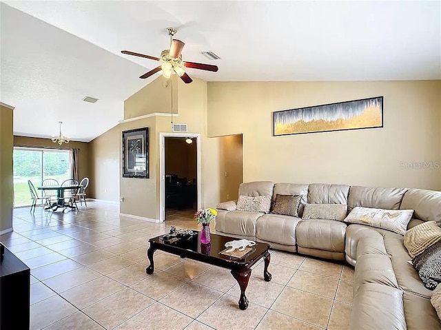 living room featuring ceiling fan, lofted ceiling, and light tile patterned floors