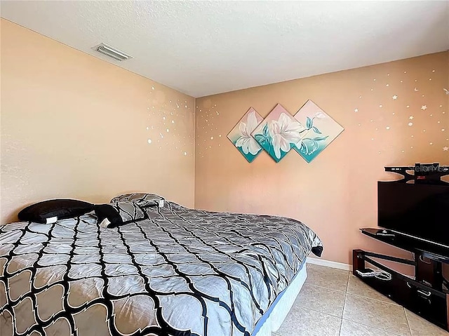 bedroom with light tile patterned floors