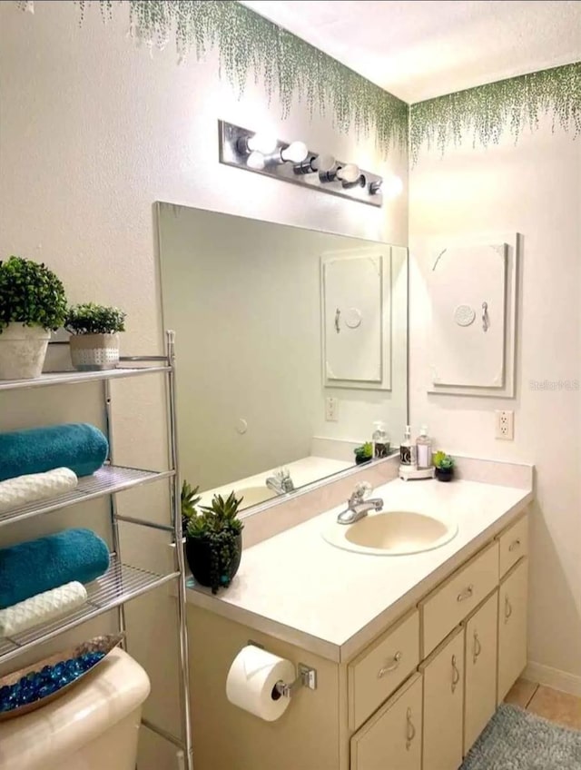 bathroom with tile patterned flooring and vanity