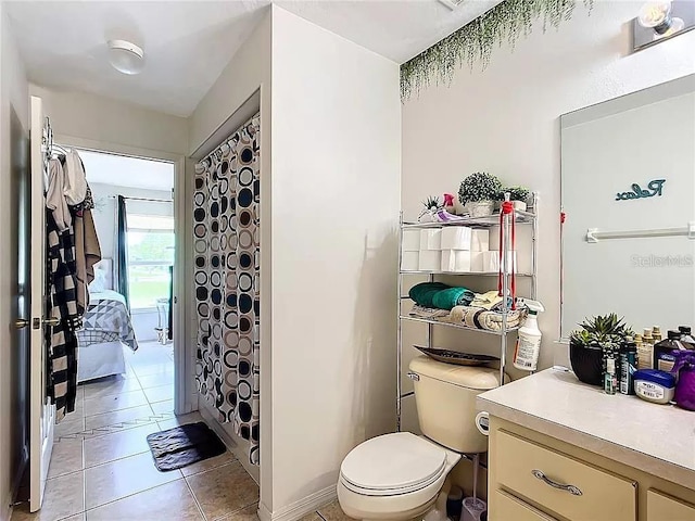 bathroom with tile patterned flooring, vanity, and toilet