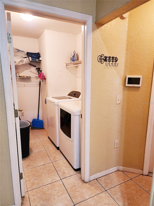 washroom with light tile patterned floors and independent washer and dryer