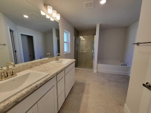 bathroom featuring independent shower and bath and vanity