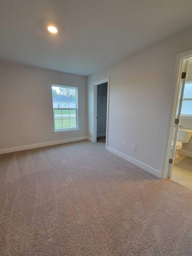 unfurnished room with light carpet