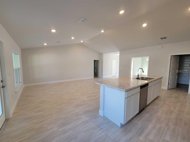 kitchen with dishwasher, an island with sink, sink, white cabinets, and light stone countertops