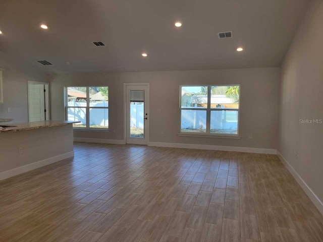 empty room with light hardwood / wood-style flooring