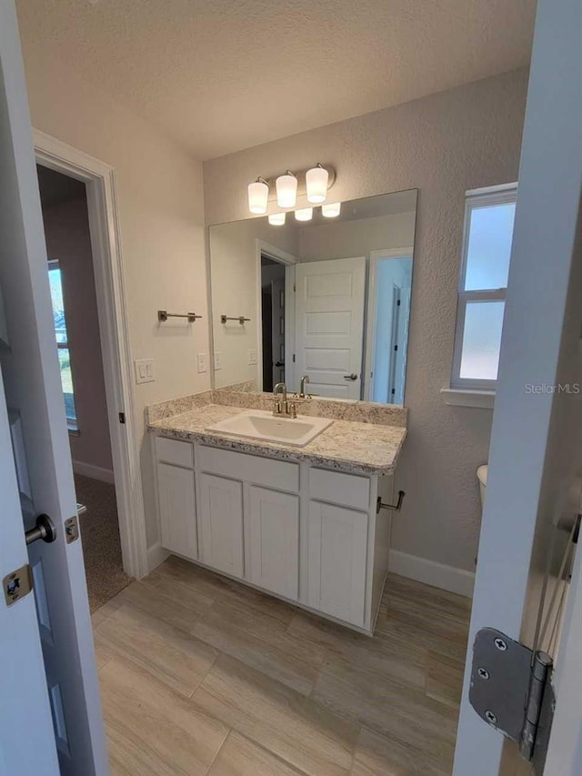 bathroom featuring vanity and a textured ceiling