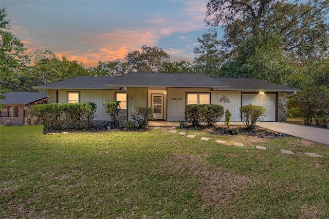 single story home with a lawn and a garage